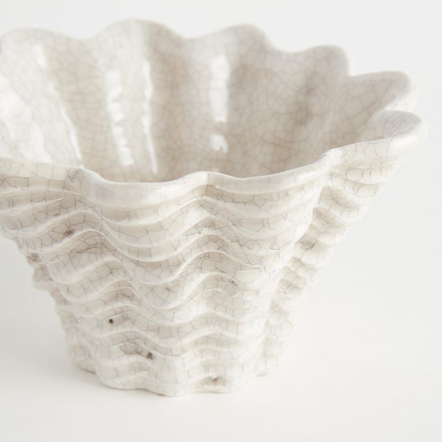 With an antique subtle crackle glaze, this generously scaled shell vase is a stunning accent. Whether on a side table,...