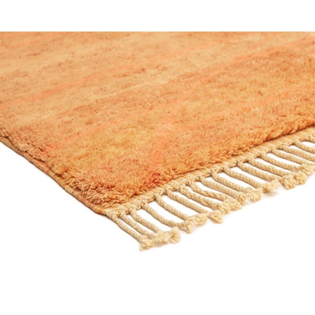 A sunset caught mid-fade, warm from edge to edge. This hand-knotted wool rug builds its impact through a sweeping ombré...