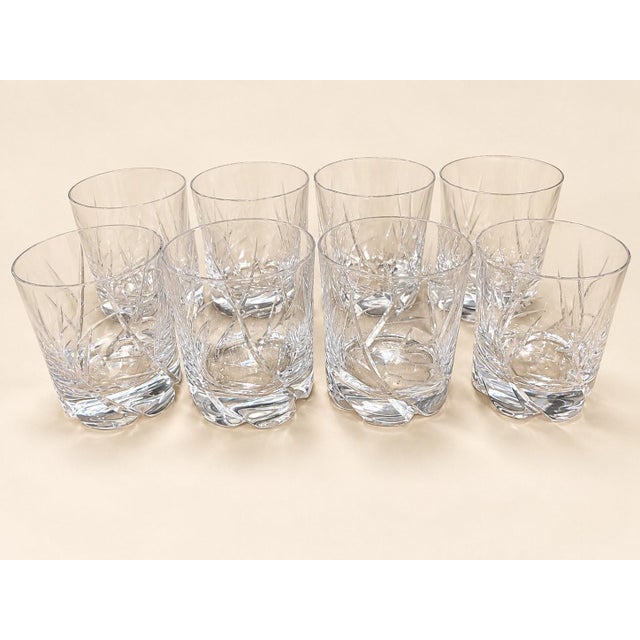 A set of eight cut crystal port glasses by daum, a true treasure of early 20th-century french glassmaking. each glass...