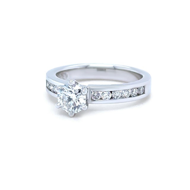 A timeless diamond ring crafted in 18ct white gold, featuring a round brilliant cut diamond in a classic six-claw setting...