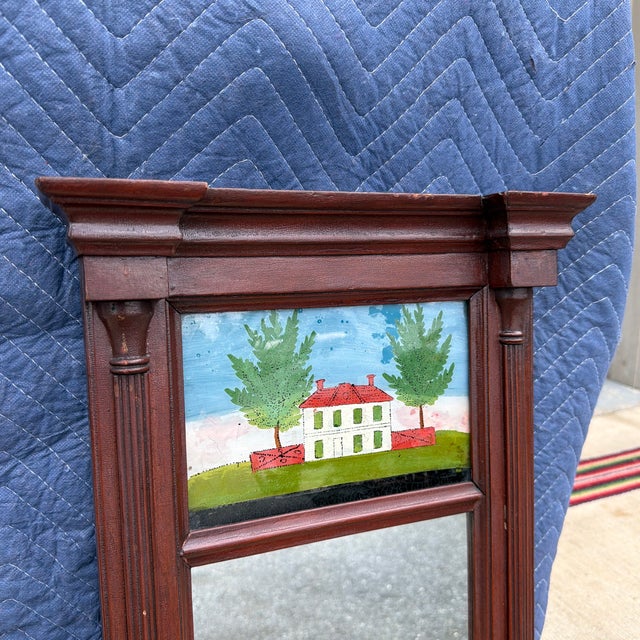 Antique Pennsylvania Country Federal Two-Part Hall Mirror with Reverse Painted Églomisé Panel, Circa 1820s A charming and...