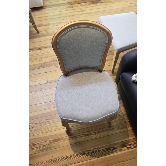 This Kravet dining chair features a refined Italian-inspired design with a sculpted solid wood frame and gracefully curved...