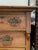Antique dresser with carved wood details, and detailed iron hardware. Lots of wear and imperfections consistent with age...