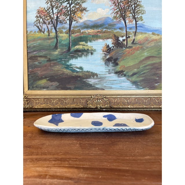 This handmade studio pottery tray features an organic oval form with hand-rolled edges and a subtle cream glaze accented...