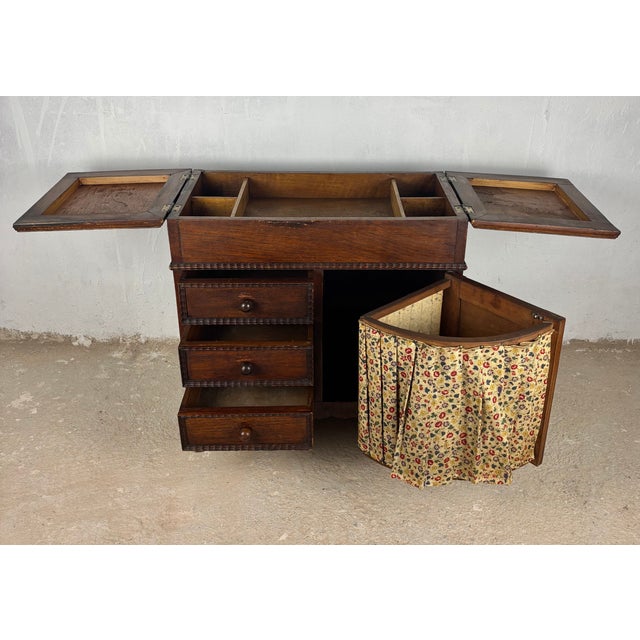 Early 20th century Spanish sewing cabinet crafted in solid oak with a warm rustic patina and highly functional interior....