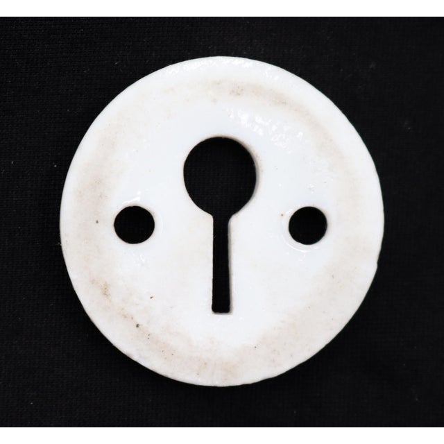 Vintage circular white ceramic keyhole cover. The original mounting screws are not available. Good condition with surface...