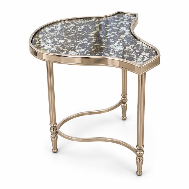 A sophisticated set of three Cartouche nesting cocktail tables by Global Views, featuring elegantly contoured antique...