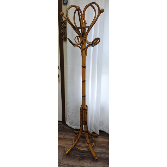 This striking item is a 1960s Italian Mid-Century Modern bamboo and rattan standing coat rack, distributed and imported by...