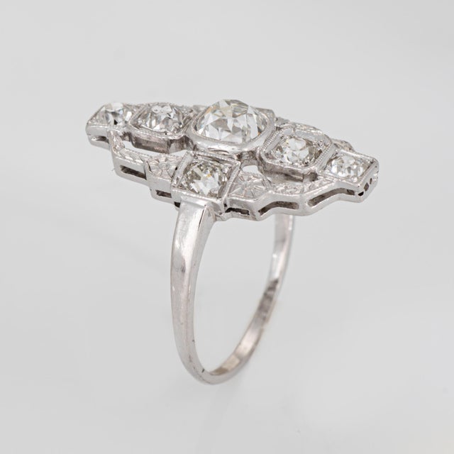 Finely detailed vintage Art Deco diamond ring (circa 1920s to 1930s) crafted in 900 platinum. Old mine cut diamonds total...