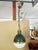 A pair of globe pendant lights designed by interior designer Thomas O'Brien for Visual Comfort & Co. The top parts consist...
