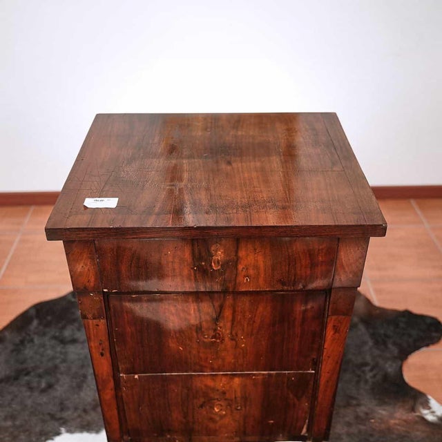 Walnut slab cabinet, three drawers height: 78 width: 55 depth: 46 seat height: 47 this piece is attributed to the...