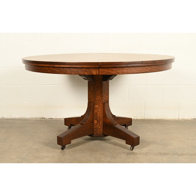 An exceptional antique Mission or Arts & Crafts period quarter sawn oak pedestal extension dining table In the manner of...