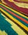 Handwoven wool flatweave area rug in a Mexican serape / Saltillo-style, featuring bold Southwestern geometric banding and...