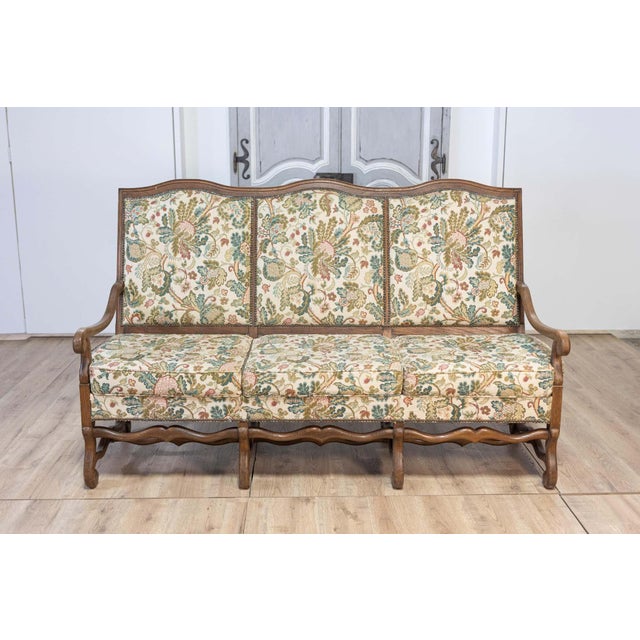This exquisite 20th Century French Walnut Mutton Leg Sofa is a timeless piece of French provincial design. Crafted from...