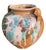 Vintage terracotta cachepot featuring a classic amphora form with twin handles and an expressive multicolor drip glaze...