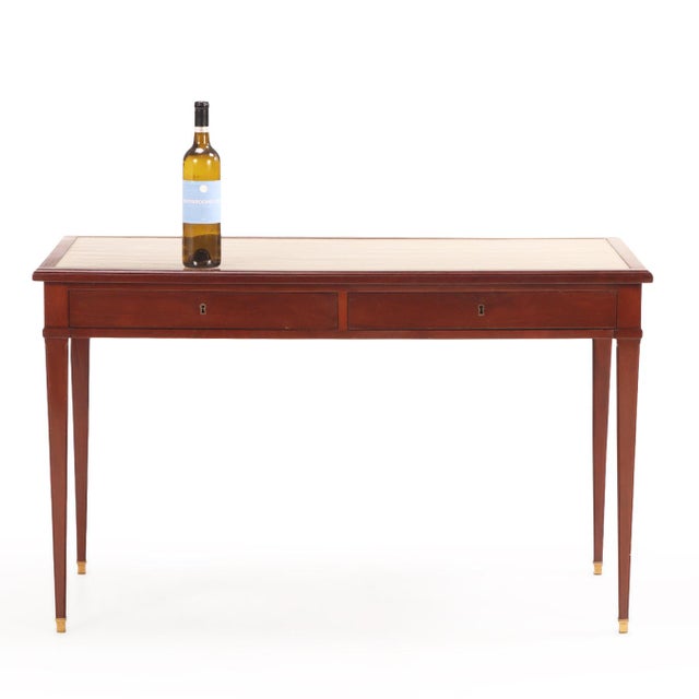 Petite solid mahogany leather top writing desk in the manner of Jean-Michel Frank, constructed in the 1940’s. Pull out...