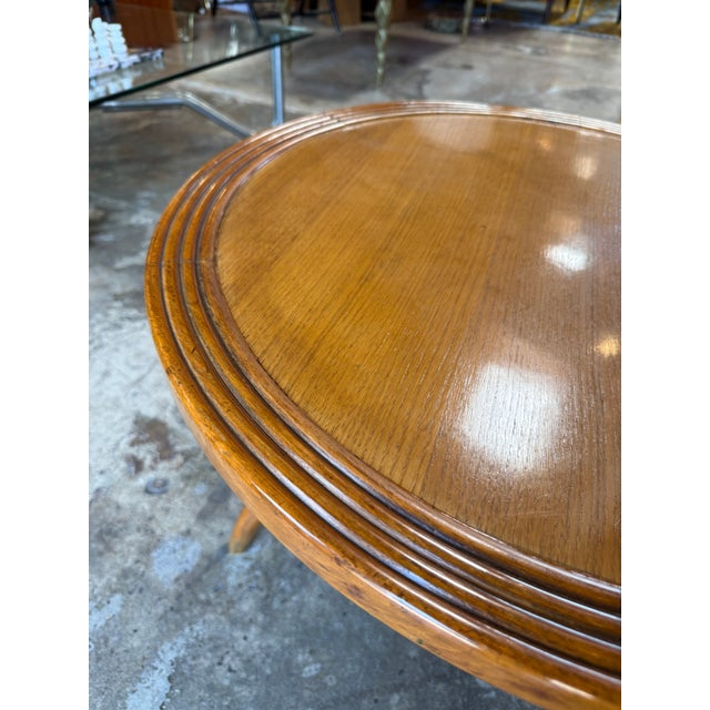 Elegant mid-century Italian side table crafted in warm walnut, featuring a circular top with finely stepped rim detailing....
