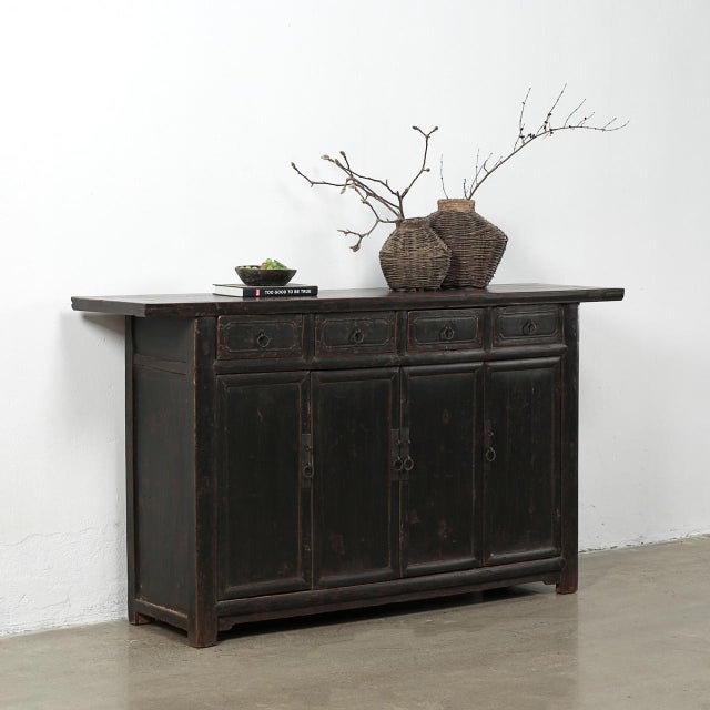 Handcrafted with a distressed black lacquer finish, this vintage 70-inch sideboard brings moody sophistication and...