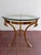 Beautiful vintage Hollywood Regency brass and glass side table, circa 1960s / 1970s. The sculptural brass base features...