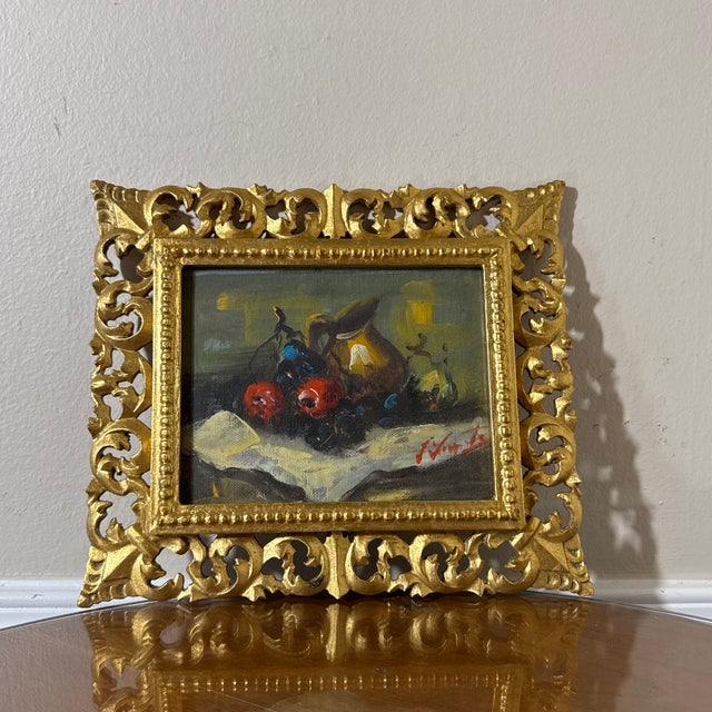 Beautiful vintage Italian still life painting featuring a classic composition of fruit, wine bottle, and table setting....