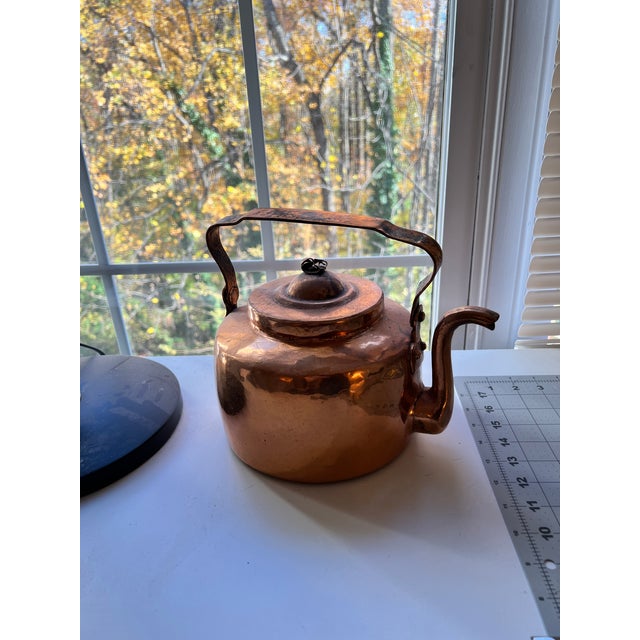 This evocative early 20th-century copper kettle exemplifies the quiet beauty of utilitarian European metalwork. Hand-...