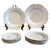An exquisite set of twelve Royal Limoges plates, crafted in luminous white porcelain with the graceful scalloped “Nymphéa”...