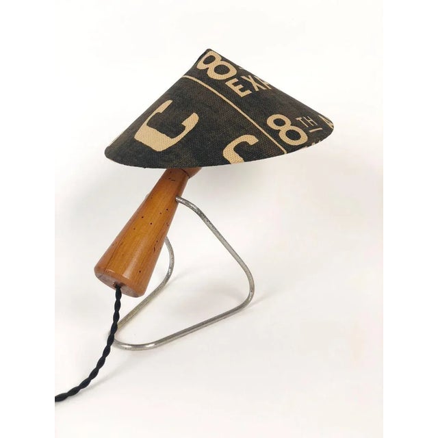 A playful midcentury table lamp in oak and metal. Produced in the early 1950s in Czechoslovakia, it has been rewired with...