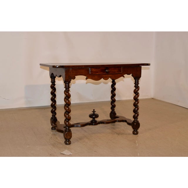 Mid-18th-century walnut side table from France with banded ends on the top, over wonderfully hand scalloped aprons on...