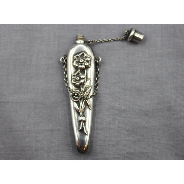 Circa 1890s sterling silver chatelaine scent bottle, American. Repousse floral banded bouquet. No maker's mark. 0.50 troy...