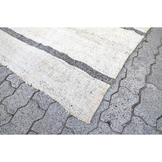 This is a vintage Turkish Oushak rug from the 1960s. The piece was hand-knotted.