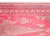 An exquisite antique Persian Kirman Suzani hand-woven silk textile featuring a vibrant red ground adorned with intricate...