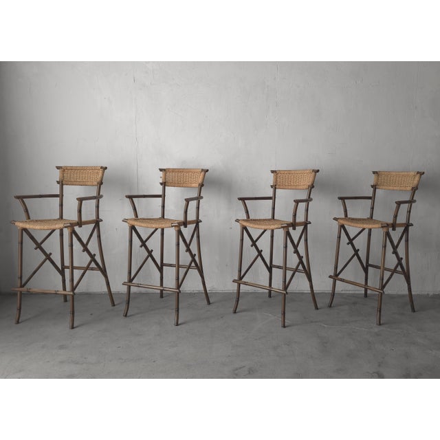 Set of 4 vintage metal, faux bamboo and woven rope barstools. Stools are great quality, built to truly last. They are in...
