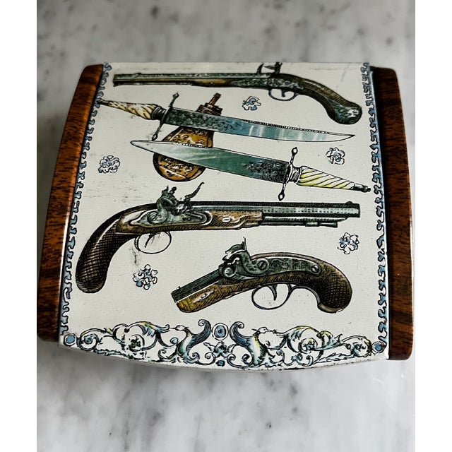 Mid-Century metal box attributed to Fornasetti with domed lid and side panels decorated with wood grain around and antique...