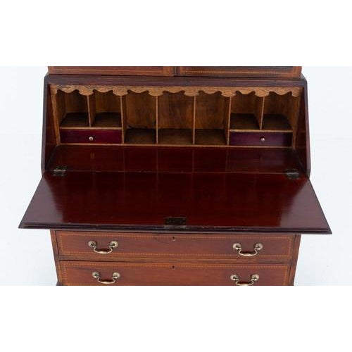 Sheraton Revival mahogany bureau bookcase This bureau bookcase is raised upon shaped bracket feet The lower section having...