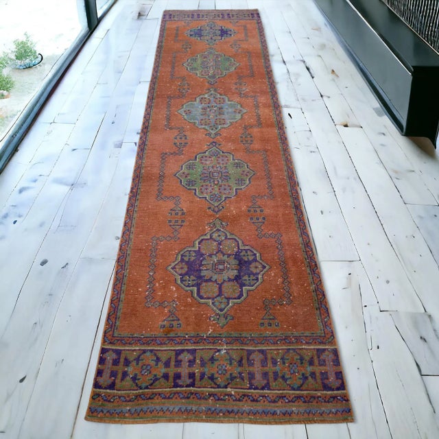 A vintage, zest background, distressed Turkish Oushak rug runner with a floral motif and large design elements. Great...