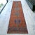 A vintage, zest background, distressed Turkish Oushak rug runner with a floral motif and large design elements. Great...