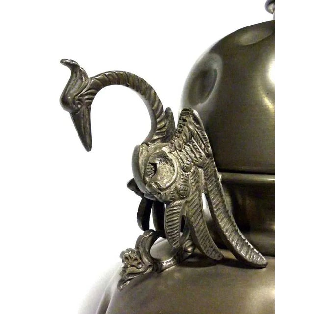 This vintage pot or vase with a lid is made of pewter.