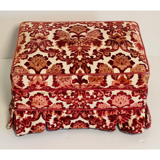Burgundy red cut velvet mid 20 th c ottoman or footstool with apron and on coasters.