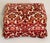 Burgundy red cut velvet mid 20 th c ottoman or footstool with apron and on coasters.
