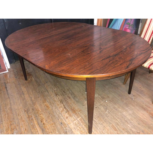 Large expanding dining table made with rich rosewood veneer. This round table comes with three 19" leaves to give you...