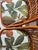 A rare matched set of 2 vintage rattan swivel bar stools, each custom upholstered in a lush tropical botanical print —...