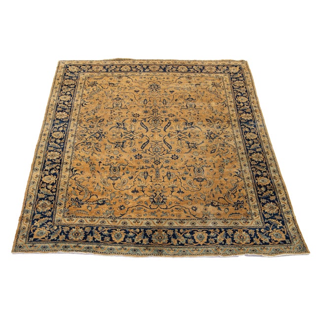 This Persian Kerman wool rug from the 20th century showcases a meticulously crafted all-over floral design in navy blue....