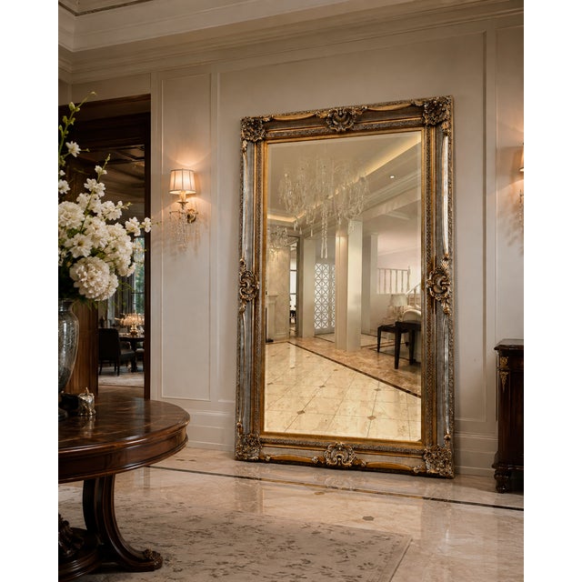 A spectacular oversized full-length mirror with commanding architectural presence and beautifully ornate detailing....