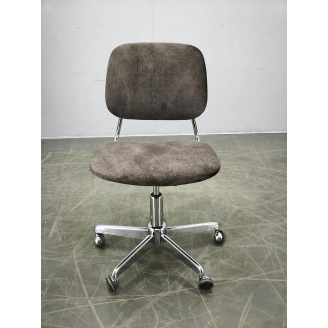 A refined Italian Mid-Century Modern office chair produced during the 1970s, combining minimalist styling with practical...