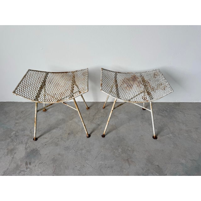 A charming pair of mid-20th century outdoor metal footstools/ottomans designed by Maurizio Tempestini for John B....