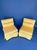 Pair of upholstered slipper chairs featuring a low-profile design, plush cushions, and skirted bases. The chairs are a bit...