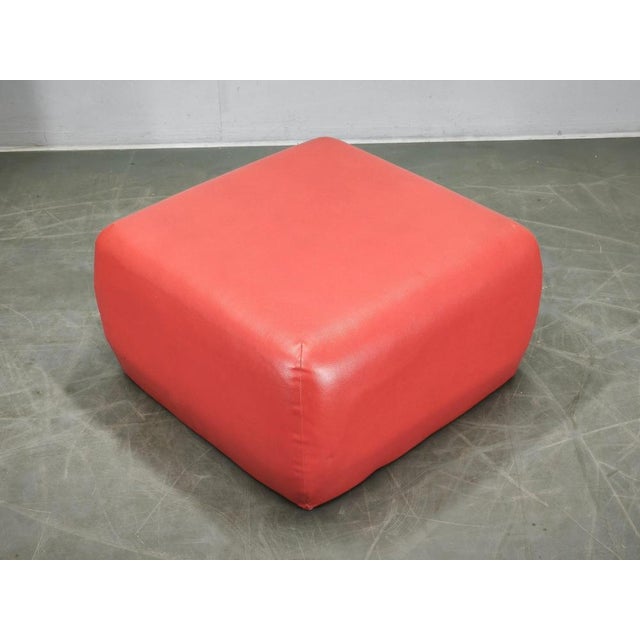 Vintage Italian Postmodern pouf / ottoman dating from the 1980s. The piece features a bold red faux leather upholstery...