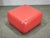 Vintage Italian Postmodern pouf / ottoman dating from the 1980s. The piece features a bold red faux leather upholstery...