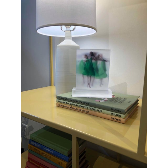 Embracing Impermanence features three ethereal figures in flowing green garments, captured in a moment of graceful...
