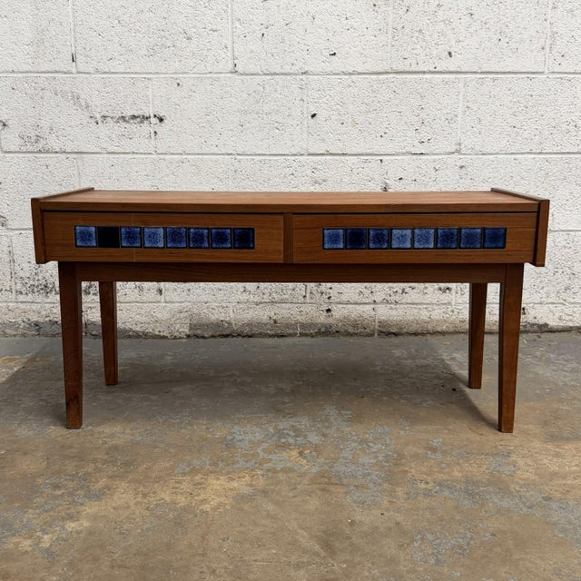 This Danish teak low entry cabinet has a great mid-century look, with a long low form, raised side edges, tapered legs,...